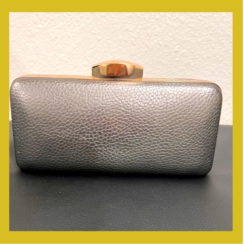 NEW! Natasha small grey with gold trim clutch. Good condition! Has small flaws.